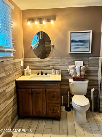 a bathroom with a toilet a sink and mirror