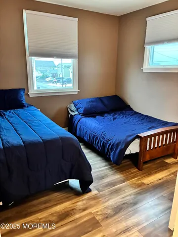 a bedroom with two beds and a window