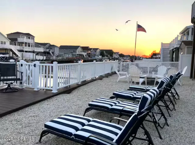 a view of a roof deck with table and chairs