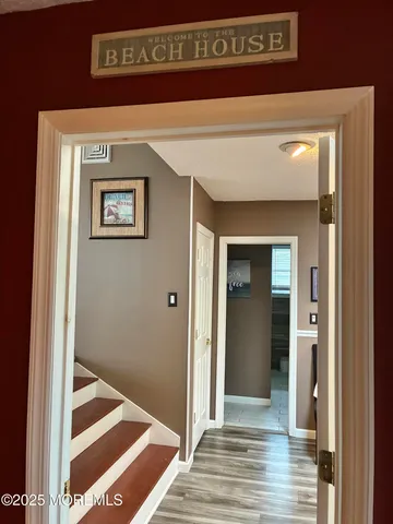 a view of a hallway with wooden floor and a hallway