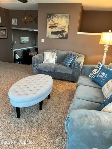a living room with furniture and a mirror
