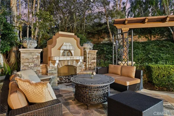a view of a patio with couches table and chairs and potted plants