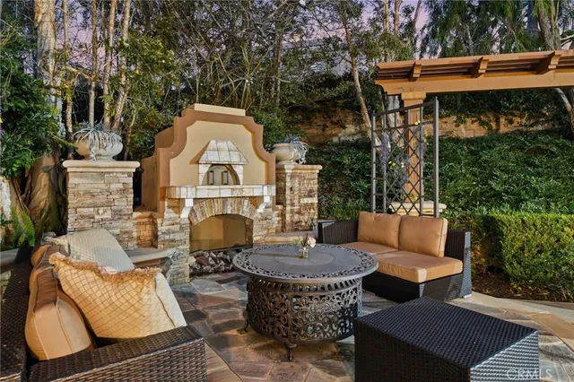 a view of a patio with couches table and chairs and potted plants