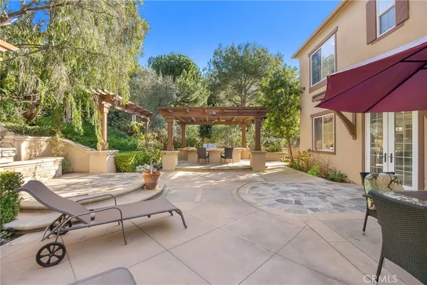 a view of patio with a table and chairs under an umbrella
