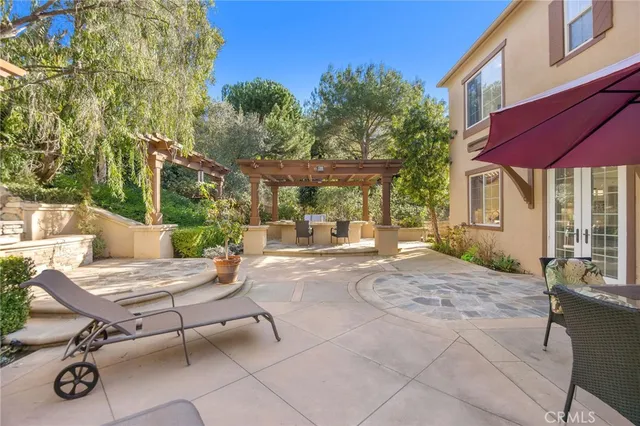 a view of patio with a table and chairs under an umbrella