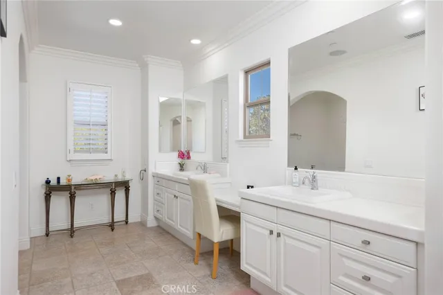a spacious bathroom with a double vanity sink mirror and