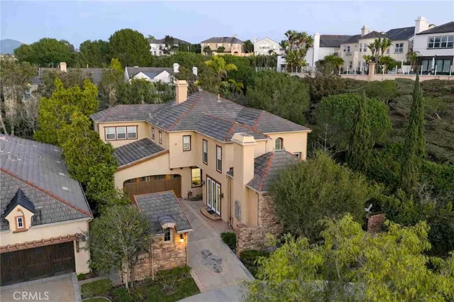 an aerial view of multiple houses with a yard