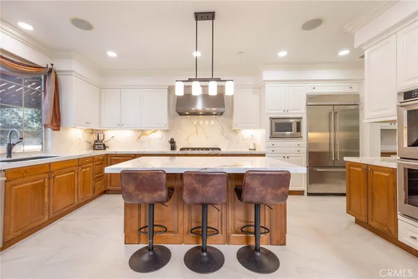 a kitchen with stainless steel appliances a sink and a refrigerator