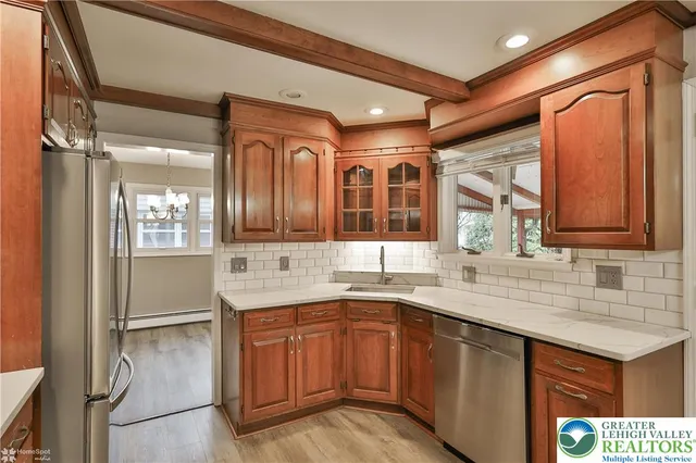 a kitchen with a sink appliances and cabinets