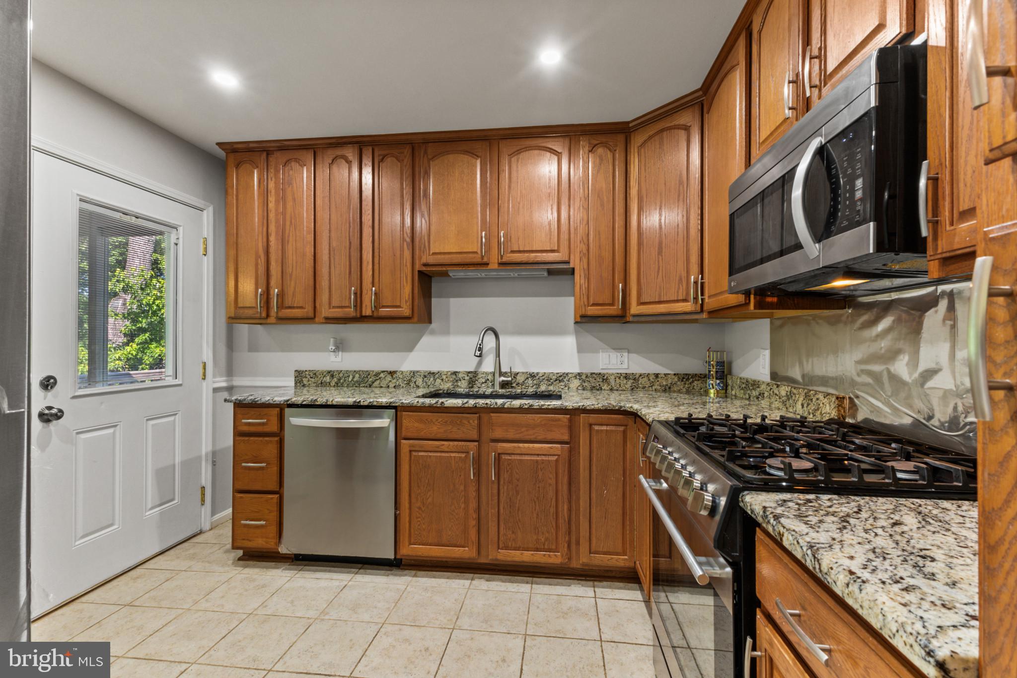403 West Poplar Road Sterling, VA 20164 - Photo 5 of 25 Modern kitchen with warm wood tones.