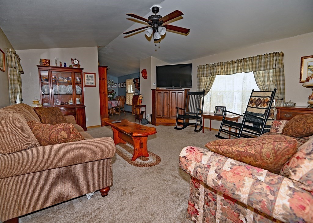 71 Timber Lane Wareham, MA 02571 - Photo 8 of 22 a living room with furniture a flat screen tv and a ceiling fan