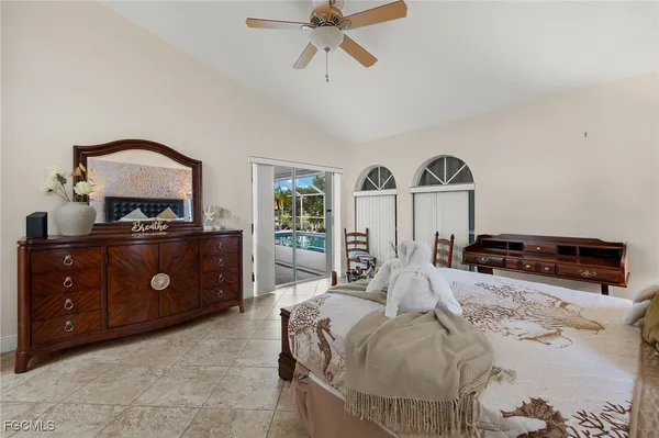 a bedroom with a bed a chandelier and a couch