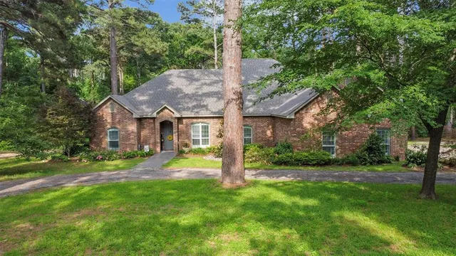 a view of a house with a yard and tree s
