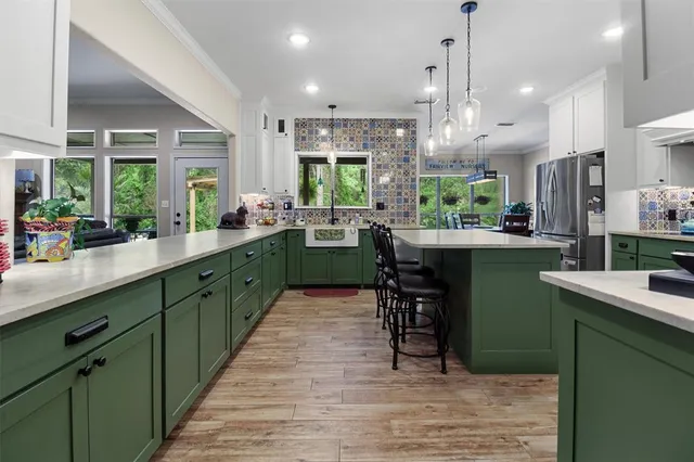 a kitchen with sink cabinets and wooden floor