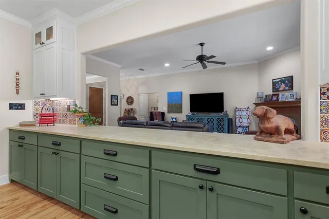 a living room with hard wood floors and a flat screen tv
