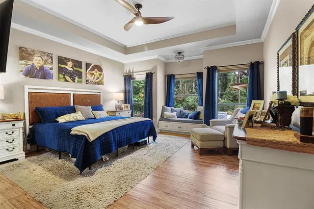 a bedroom with a large bed couch and a large window