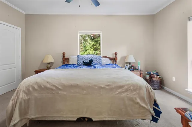 a large bed sitting in a bedroom next to a window