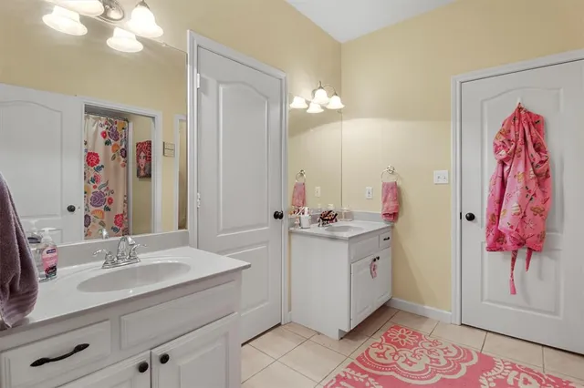 a bathroom with a double vanity sink mirror and vanity