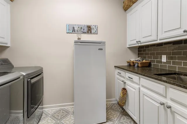 a kitchen with a refrigerator and cabinets