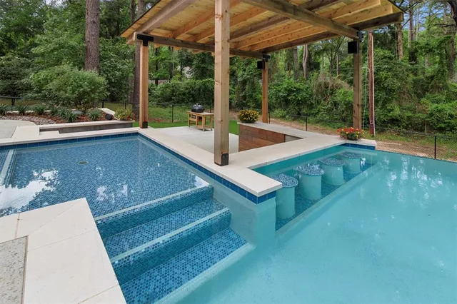 a view of a patio with a table chairs potted plants and a palm tree