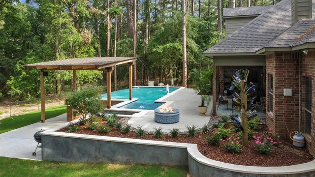 a view of a house with backyard sitting area and garden