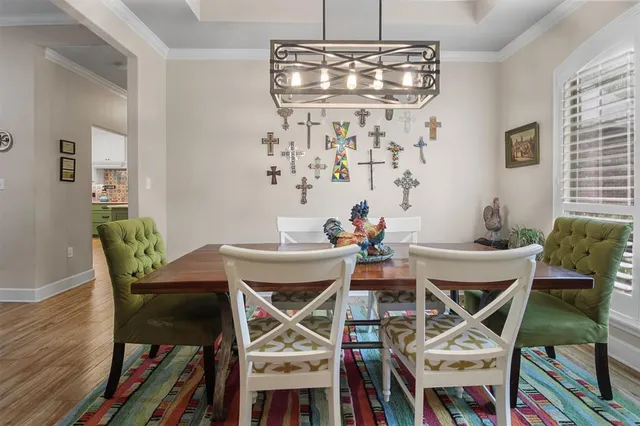 a view of a dining room with furniture and chandelier