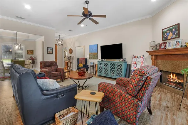 a living room with furniture a flat screen tv and a fireplace