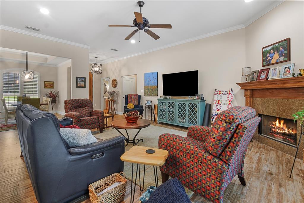 18551 Lazy Lane Flint, TX 75762 - Photo 9 of 39 a living room with furniture a flat screen tv and a fireplace
