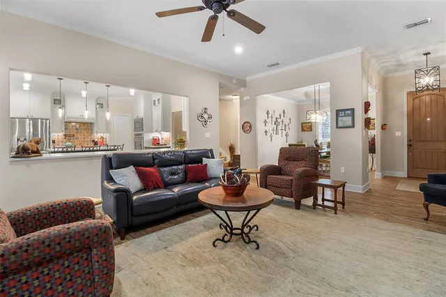 a living room with furniture and a view of kitchen