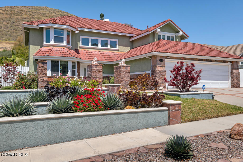 5339 Seneca Place Simi Valley, CA 93063 - Photo 68 of 76 a front view of a house with lots of flowers and trees