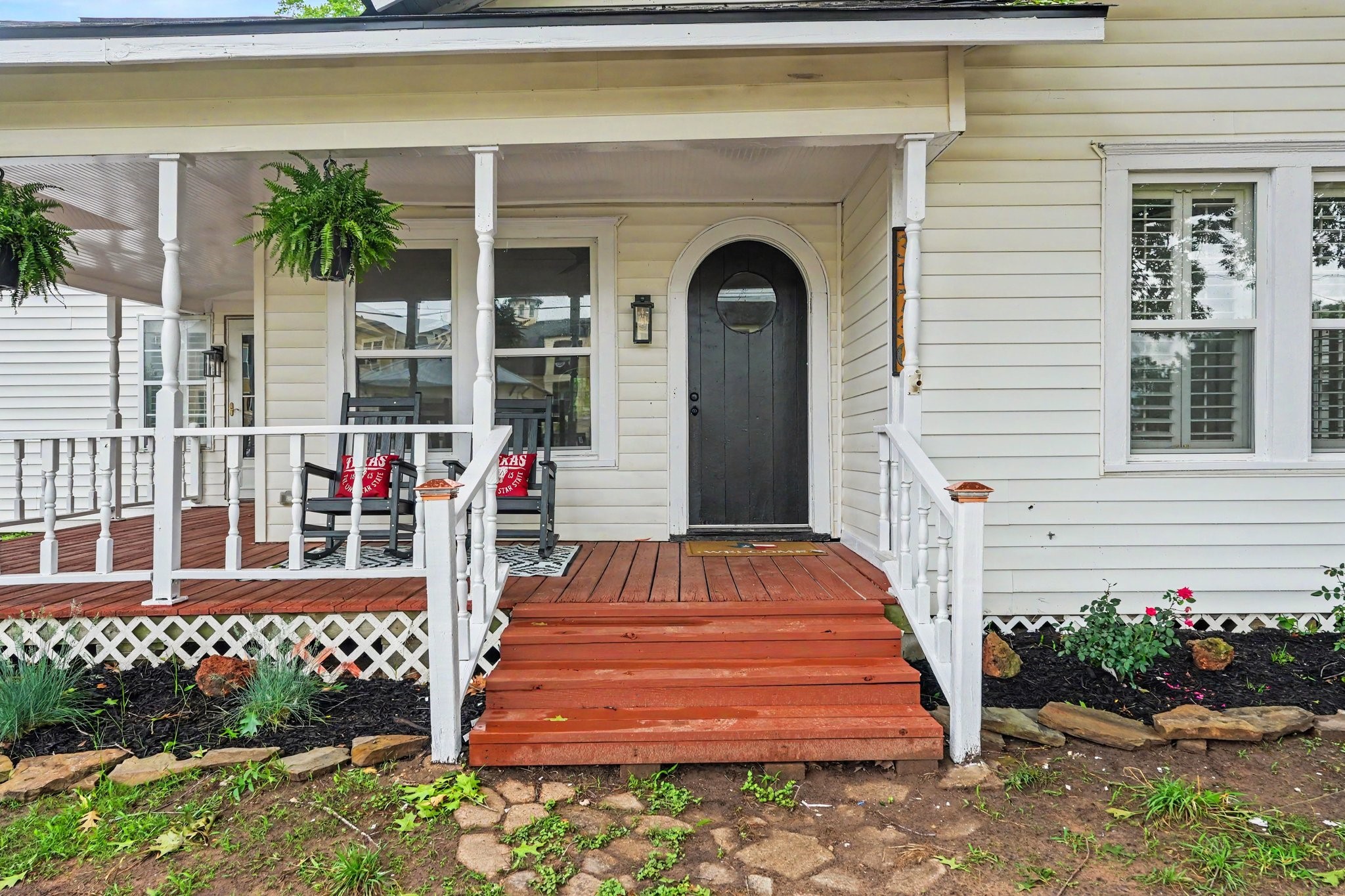 31730 Waller Tomball Road Waller, TX 77484 - Photo 5 of 50 Charming front porch with cozy seating area and a welcoming arched door, perfect for relaxing.
