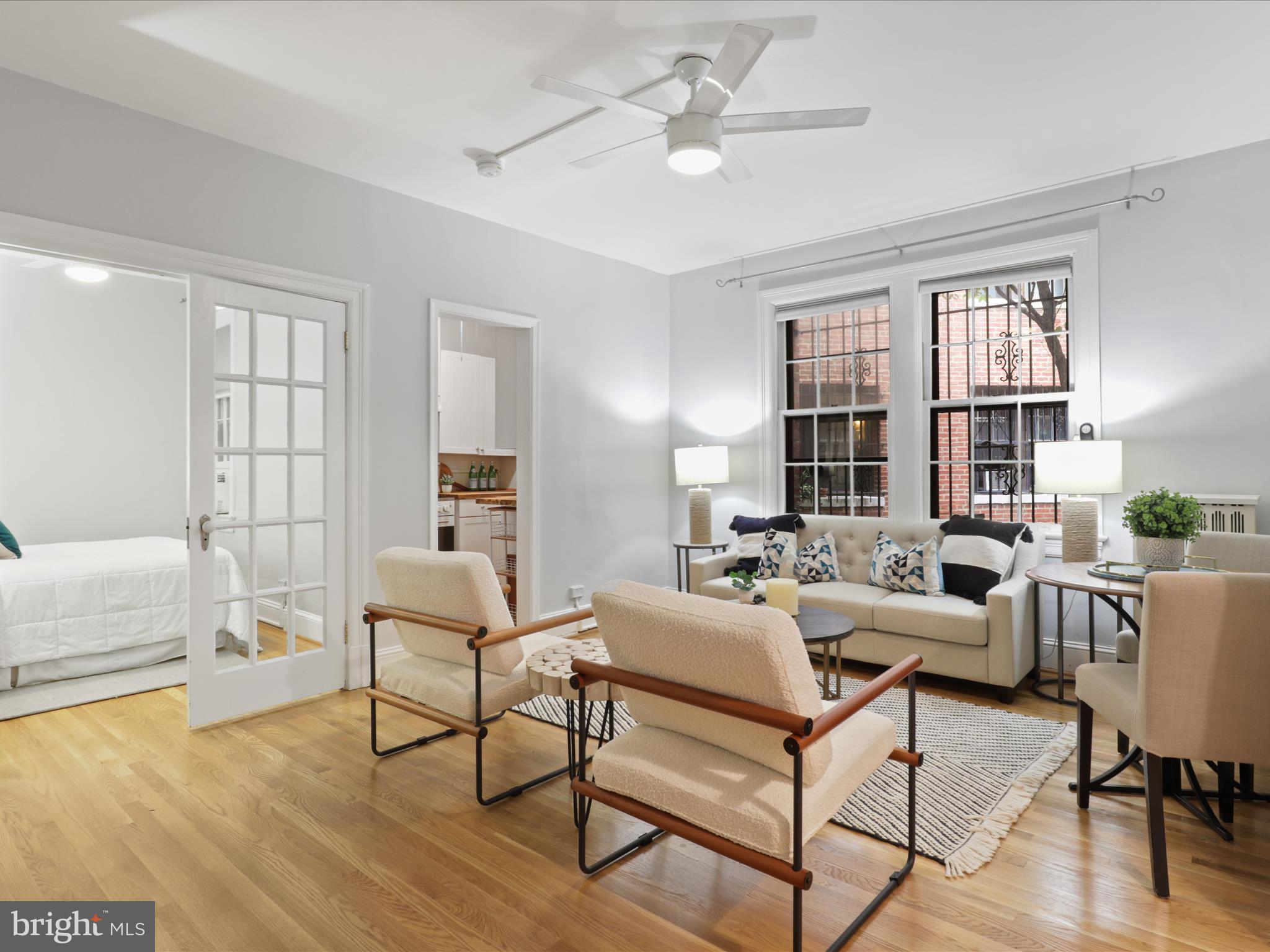 2707 Adams Mill Road Northwest, Unit 108 Washington, DC 20009 - Photo 1 of 20 a living room with furniture and a window