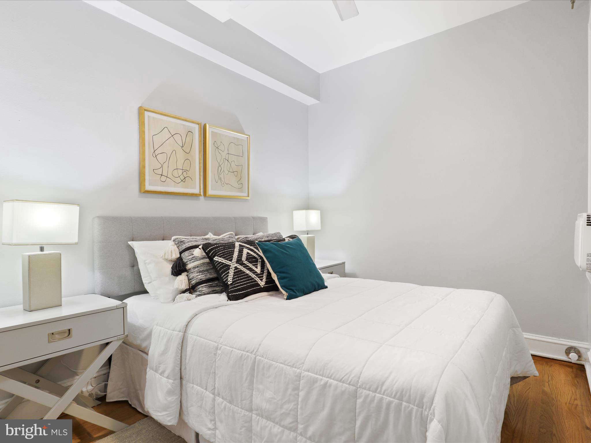 2707 Adams Mill Road Northwest, Unit 108 Washington, DC 20009 - Photo 11 of 20 a bedroom with a bed and a lamp