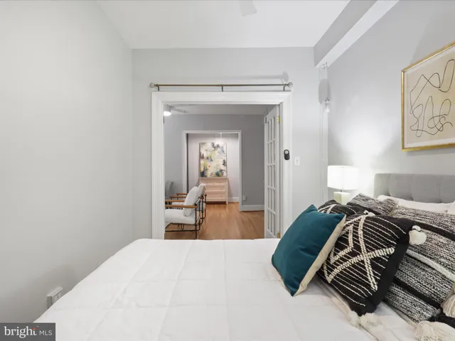 a bedroom with a bed and a mirror