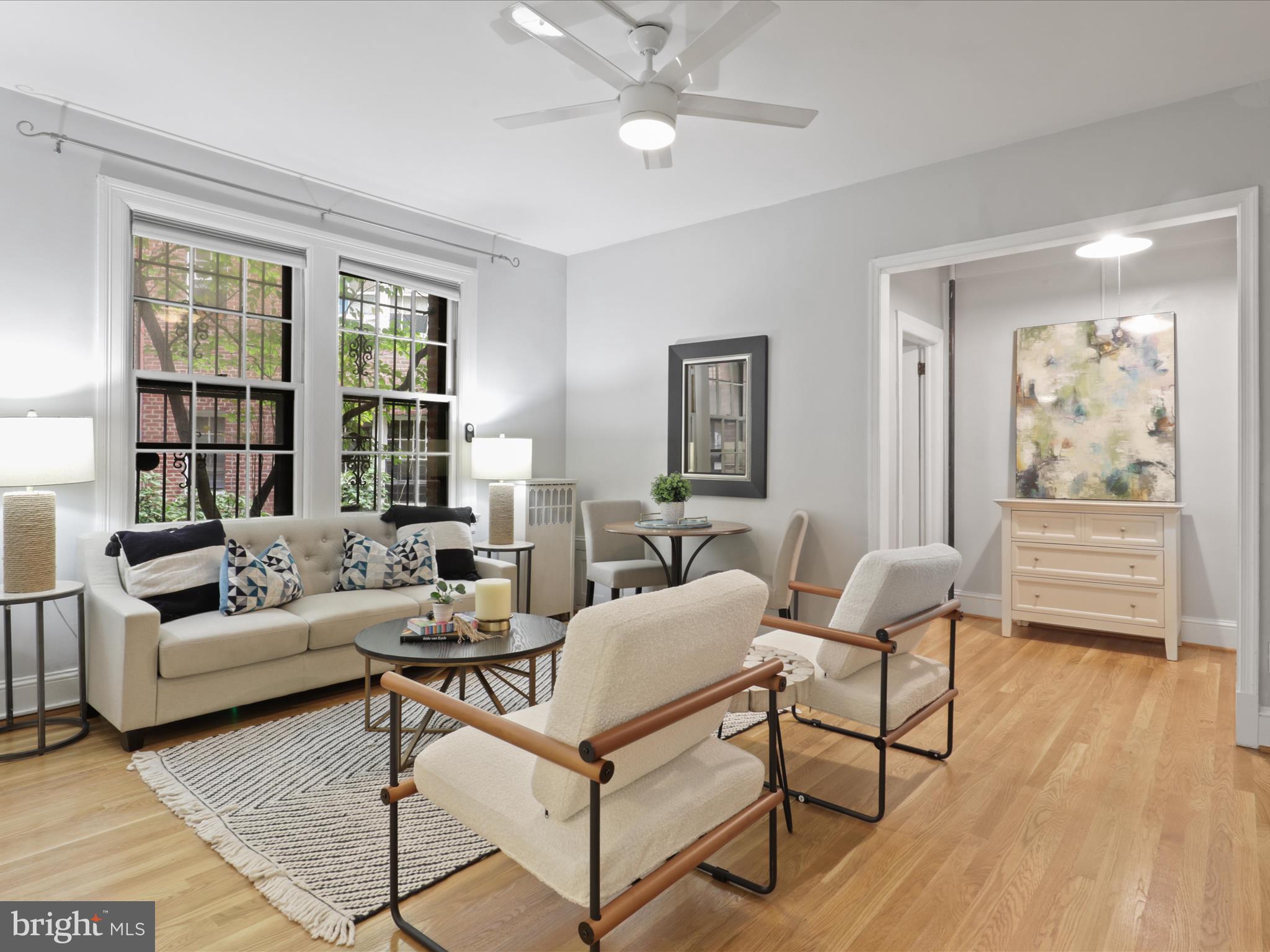 2707 Adams Mill Road Northwest, Unit 108 Washington, DC 20009 - Photo 2 of 20 a living room with furniture and a window