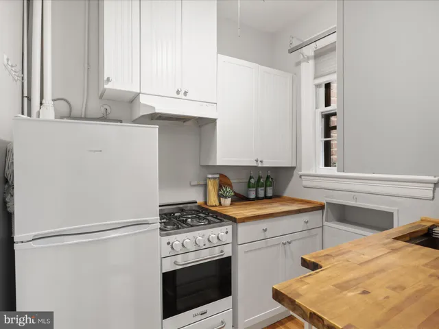 a kitchen with stainless steel appliances a stove and a refrigerator