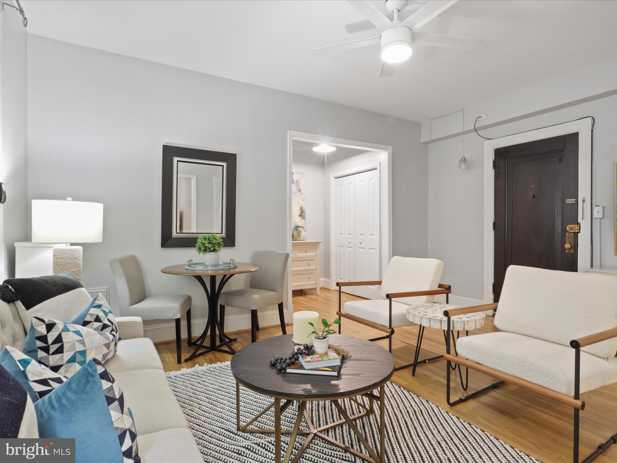 2707 Adams Mill Road Northwest, Unit 108 Washington, DC 20009 - Photo 6 of 20 a living room with furniture and a wooden floor
