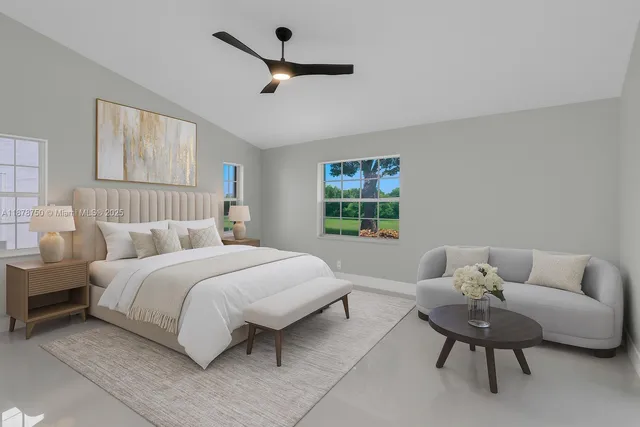 an empty room with windows and ceiling fan