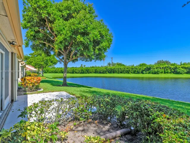 an aerial view of a house with garden space and street view