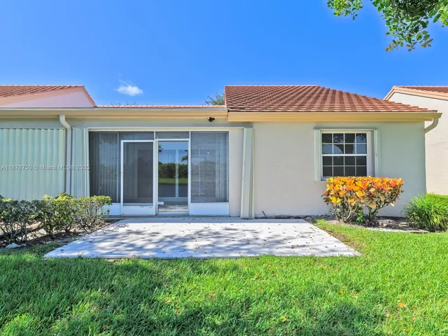 an aerial view of lake and residential houses with outdoor space and swimming pool