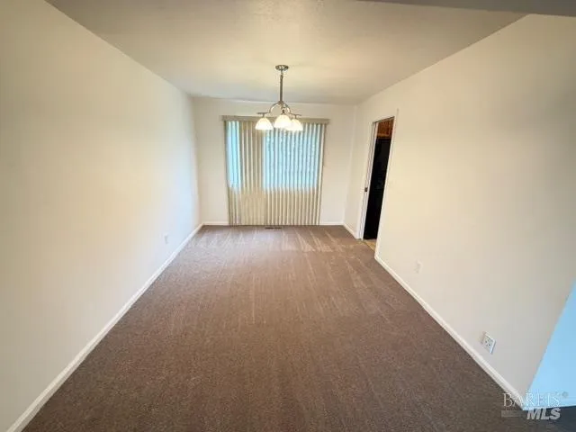 an empty room with windows and entrance