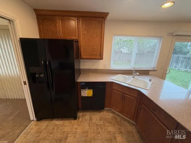 a kitchen with a sink and a refrigerator