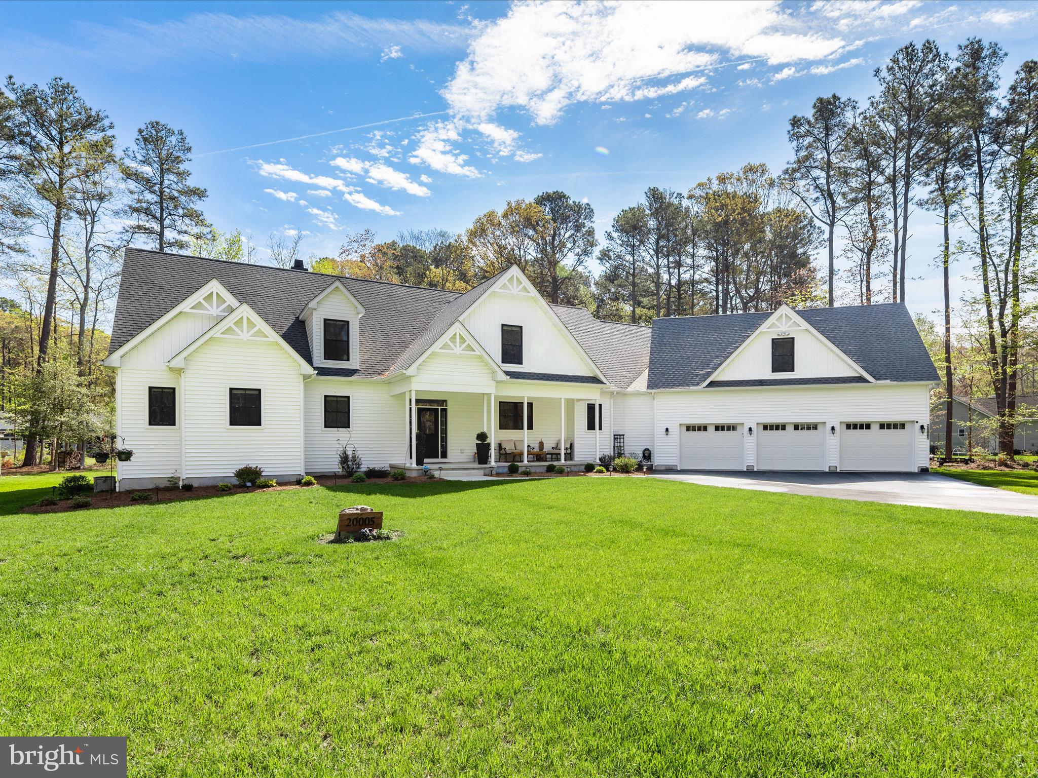 20005 Devine Way Milton, DE 19968 - Photo 1 of 82 a view of a white house in front of a big yard with plants and large trees