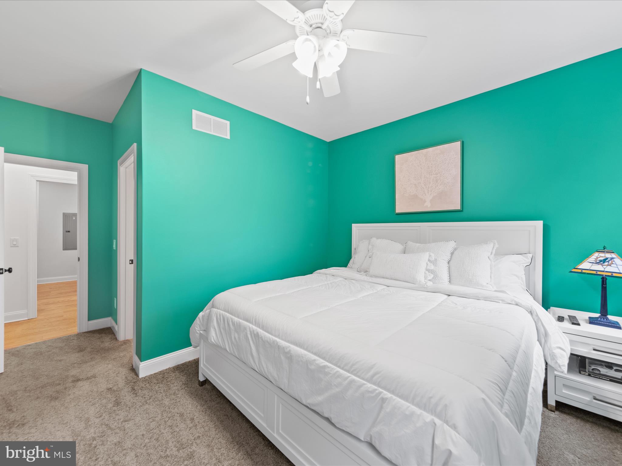 20005 Devine Way Milton, DE 19968 - Photo 39 of 82 a bedroom with a bed and a chandelier