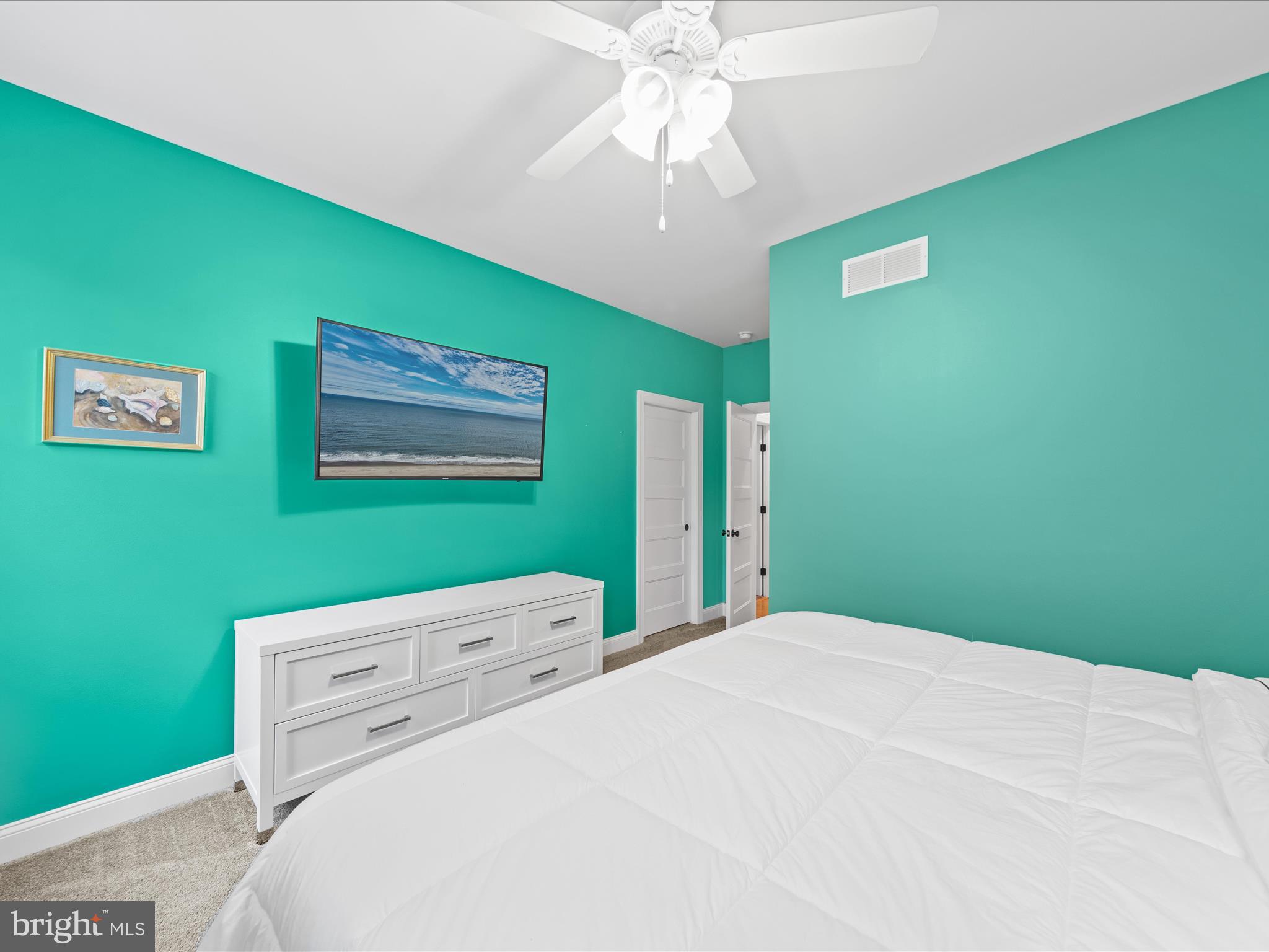 20005 Devine Way Milton, DE 19968 - Photo 40 of 82 a bedroom with a bed and a chandelier