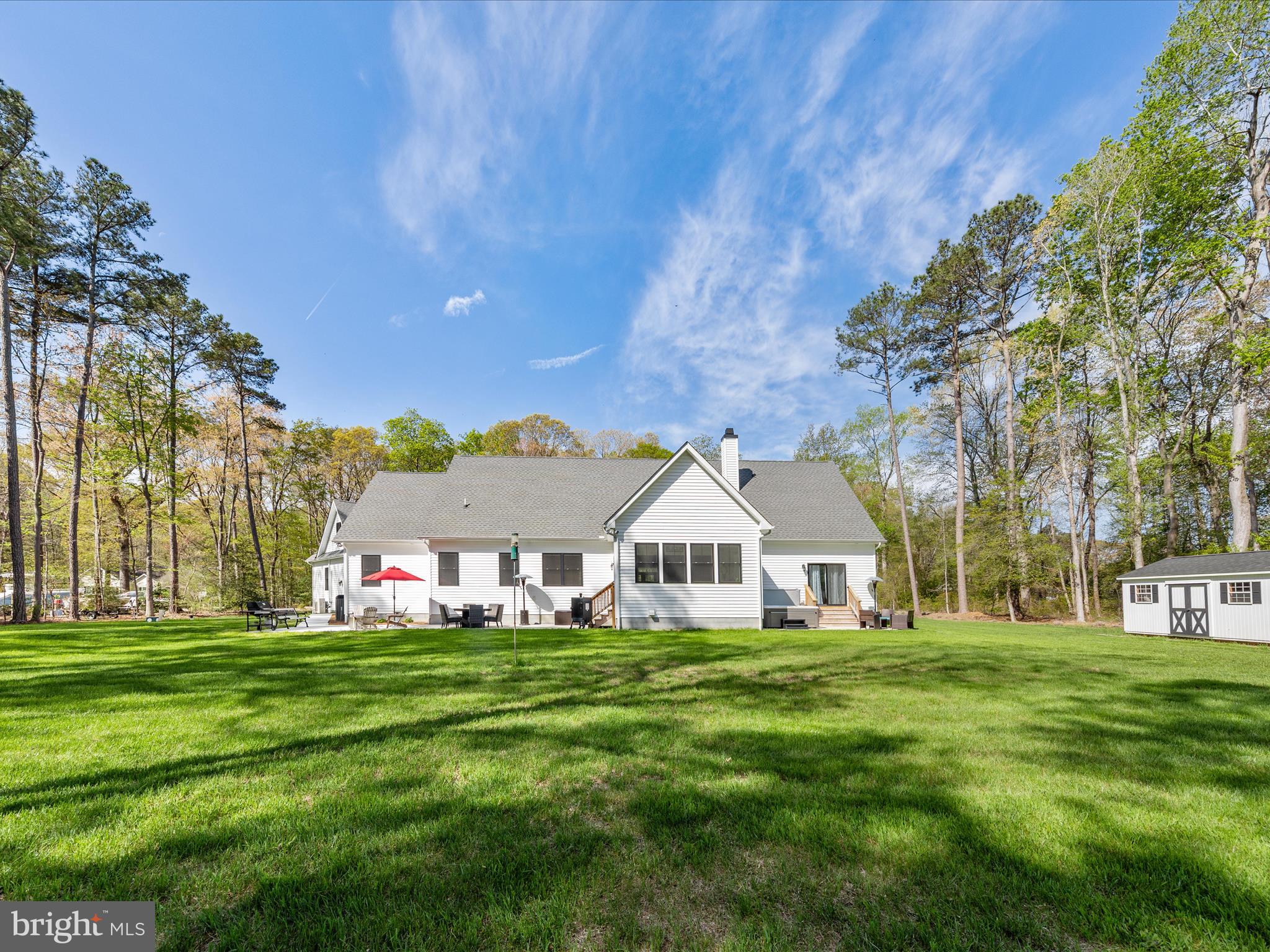 20005 Devine Way Milton, DE 19968 - Photo 72 of 82 a view of a white house with a big yard and large trees