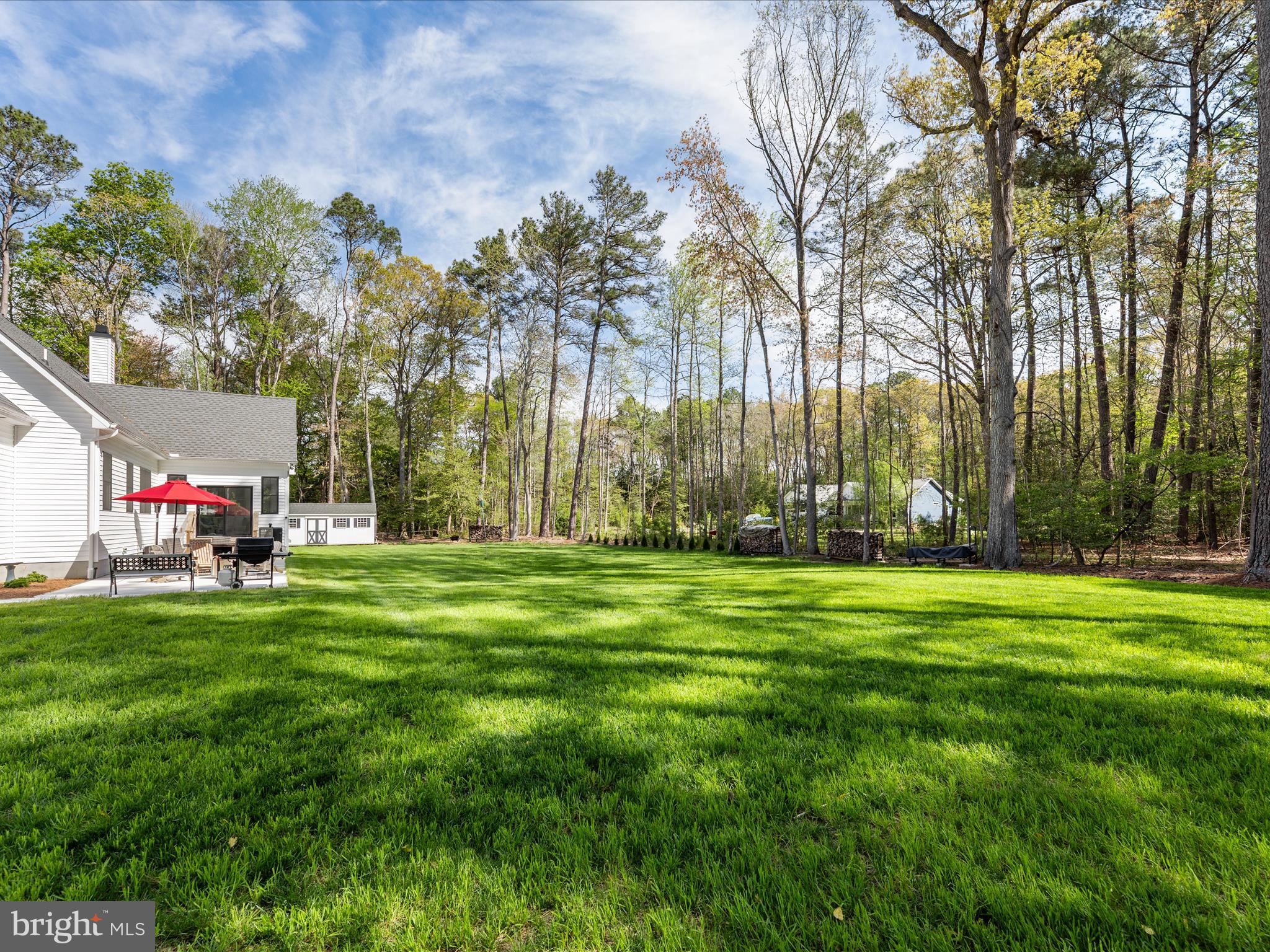 20005 Devine Way Milton, DE 19968 - Photo 76 of 82 a backyard of a house with table and chairs