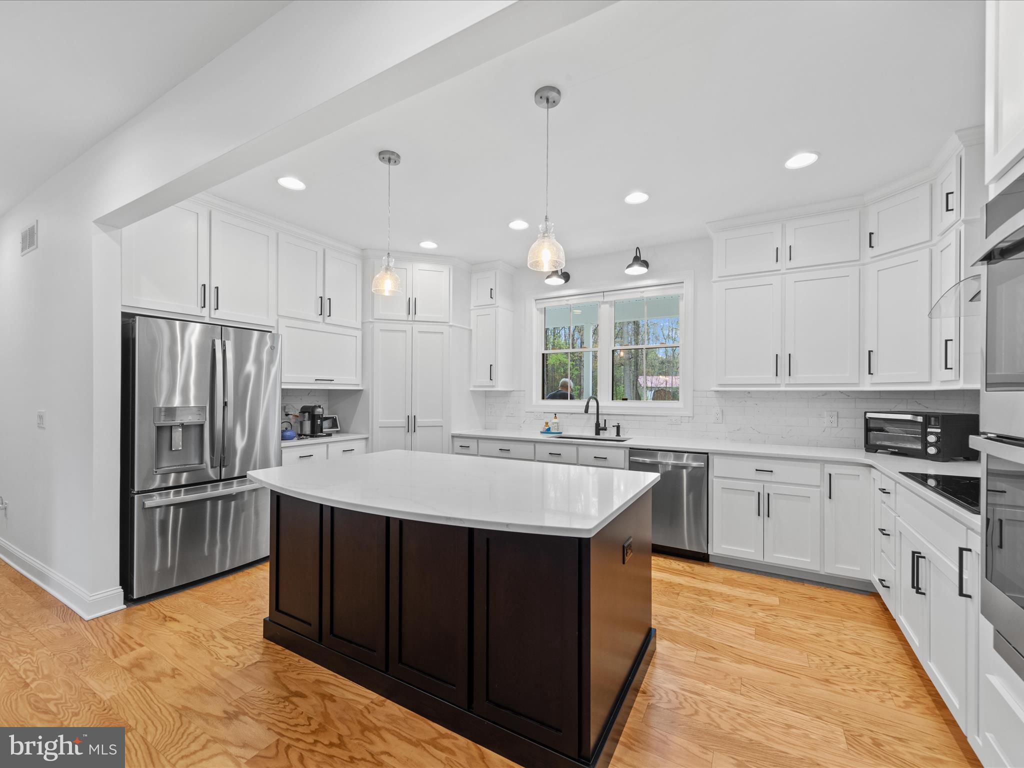 20005 Devine Way Milton, DE 19968 - Photo 8 of 82 a large kitchen with kitchen island a sink stainless steel appliances and cabinets