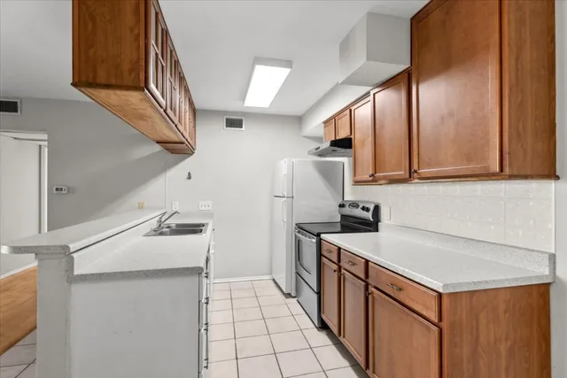 a kitchen with a sink stove and cabinets