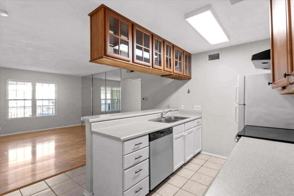 910 Duncan Lane, Unit 57 Austin, TX 78705 - Photo 13 of 34 a kitchen with a stove and a refrigerator